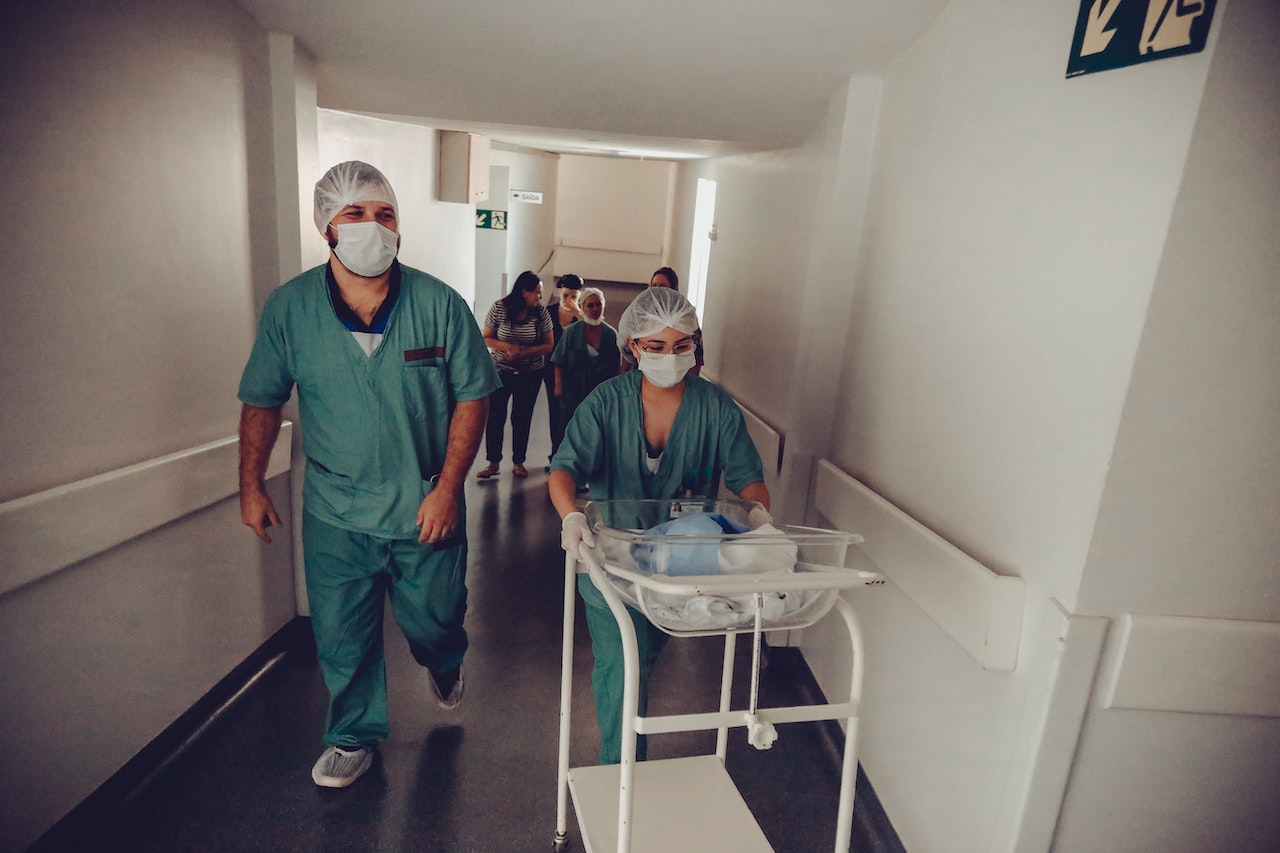 two nurses walking with medical supplies